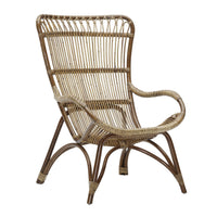 Natural woven rattan chair featuring a curved design and a light brown finish with vertical stripes. Perfect for bohemian decor.