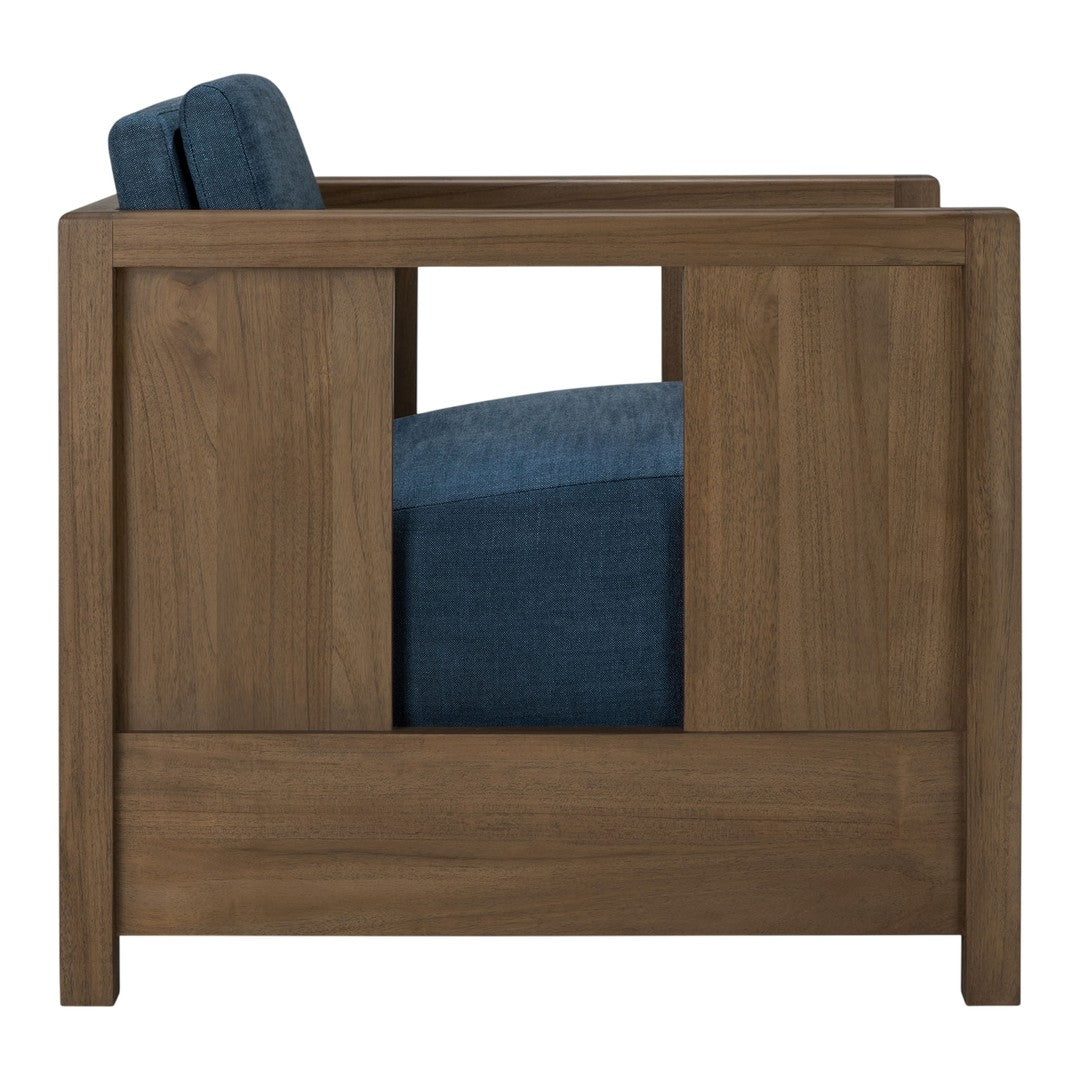 Stylish chair in deep blue upholstery with a warm wood frame and modern geometric cutout design.