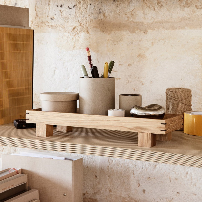 Wooden organizer tray with natural finish, featuring neutral-colored ceramic and metal accessories in a minimalist design.