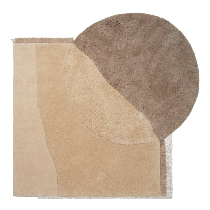 Beige rug featuring abstract shapes with a circular brown pattern and tan accents for modern decor.