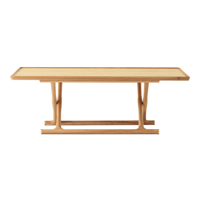 Light wood dining table with a natural finish and simple rectangular design, highlighting smooth, clean lines.
