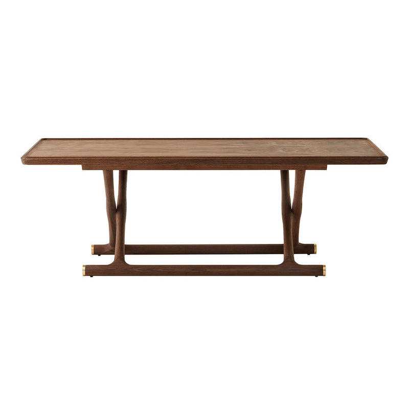 Walnut wood dining table with a smooth surface and sleek, modern design, featuring a rich brown color and subtle grain patterns.