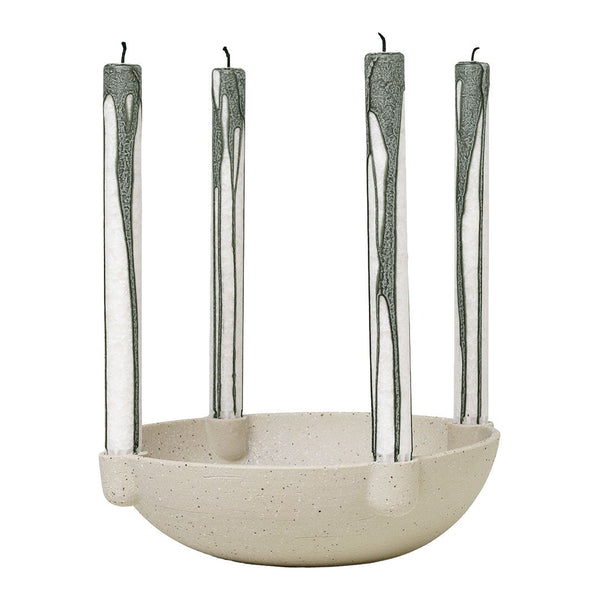 Cream bowl candle holder with green drip candles, featuring a minimalist design and smooth surface.