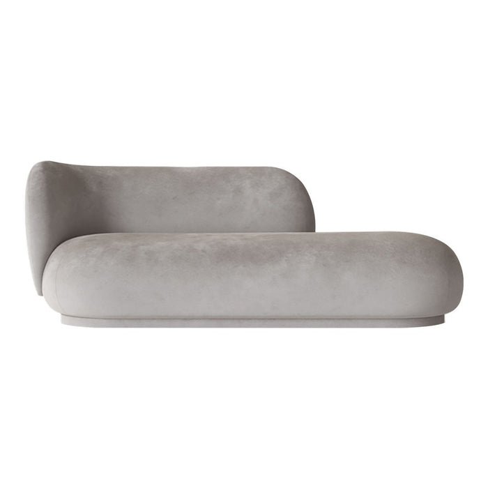 Stylish gray velvet chaise lounge with smooth, curved shapes and modern design for contemporary interiors.