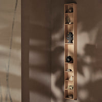 Slim wooden wall shelf in light oak showcasing smooth surfaces and natural wood grain; minimalist design with neutral tones.