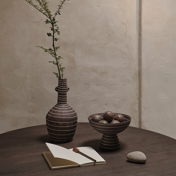 "Textured brown pottery vase and bowl with natural stones, featuring earthy tones and subtle striped patterns."