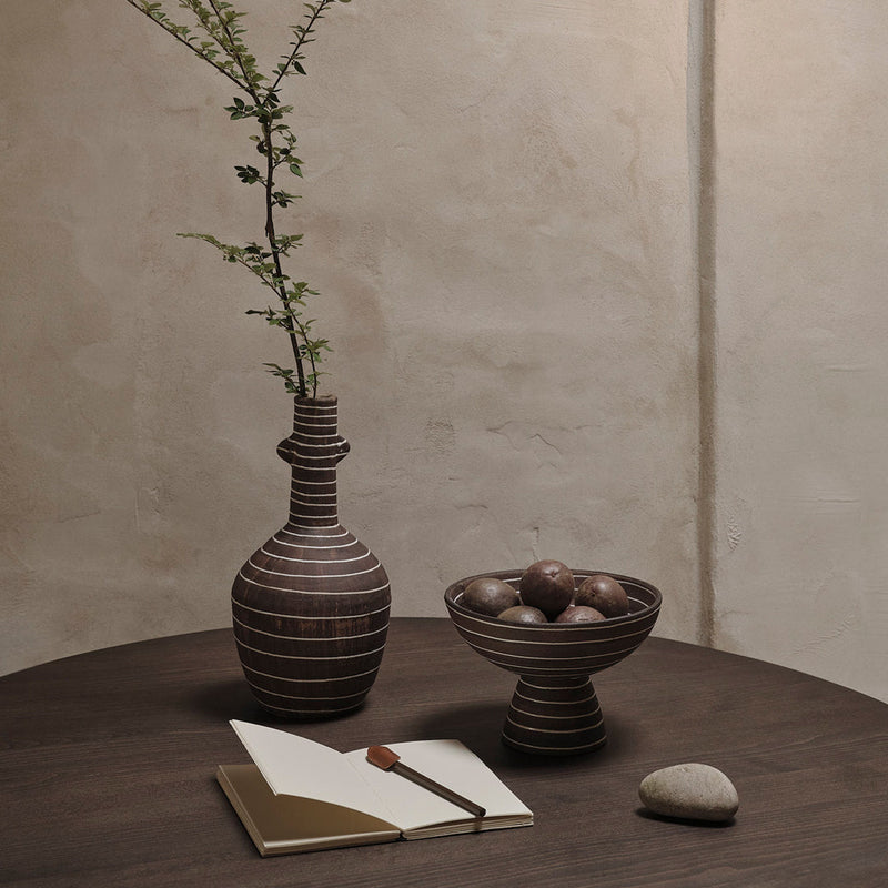 "Textured brown pottery vase and bowl with natural stones, featuring earthy tones and subtle striped patterns."