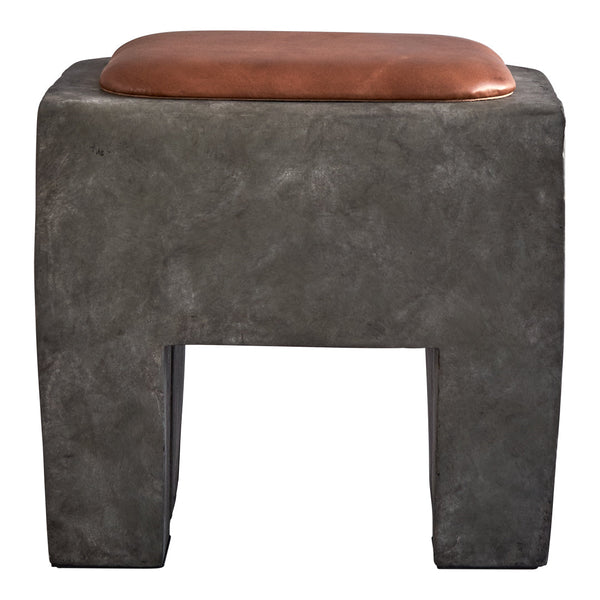 Gray concrete stool with a smooth brown leather cushion, featuring a minimalist design and geometric shape.