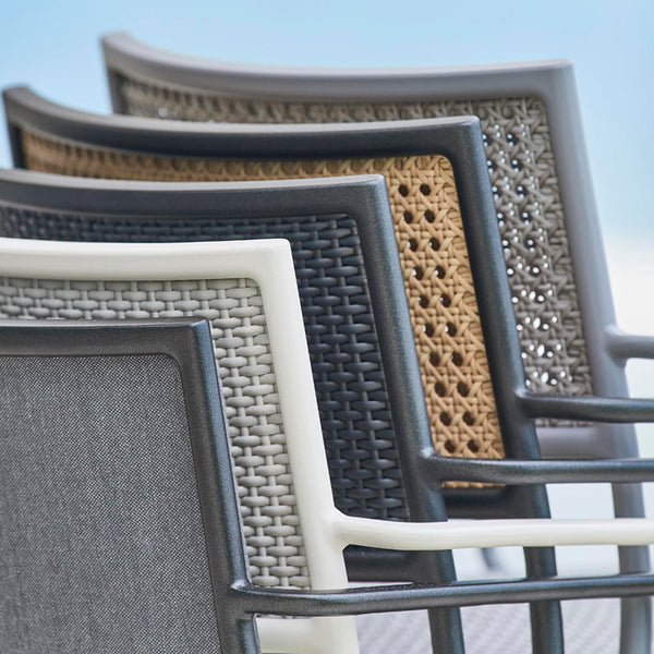Stacked patio chairs featuring gray, black, beige, and woven patterns, showcasing modern outdoor design.