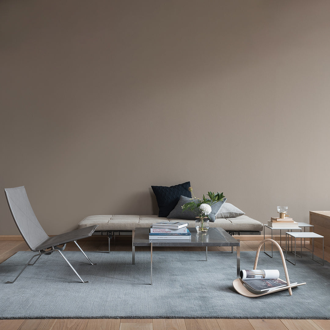 Modern grey rug in a minimalist living space with neutral tones and geometric patterns. Soft textures and sleek lines.