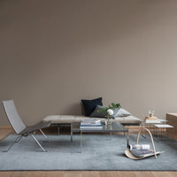 Modern grey rug in a minimalist living space with neutral tones and geometric patterns. Soft textures and sleek lines.