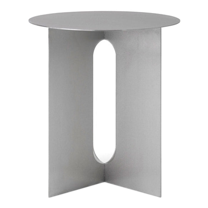 Modern silver side table with a sleek circular top and geometric cutout design. Minimalist style enhances any decor.
