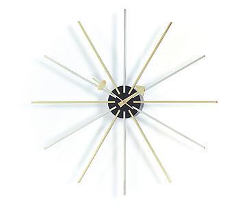 "Mid-century wall clock with black center, gold and white rays in a sunburst pattern, adding modern elegance."