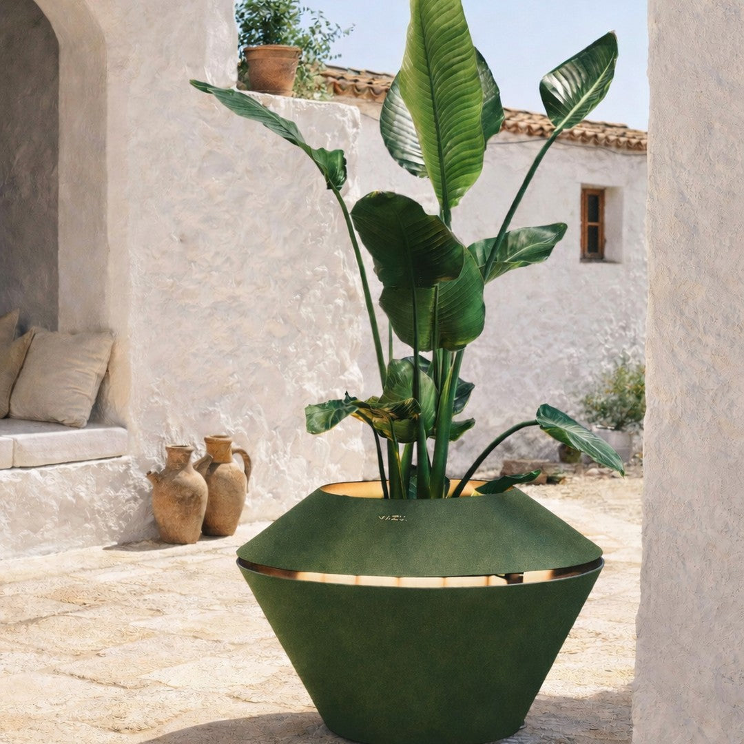 Green geometric planter with gold accents, showcasing lush green leaves and a textured surface. Ideal for modern decor.