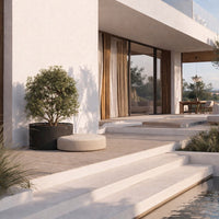 "Modern outdoor steps with sleek white concrete, complemented by earthy green plants and neutral-toned cushions."