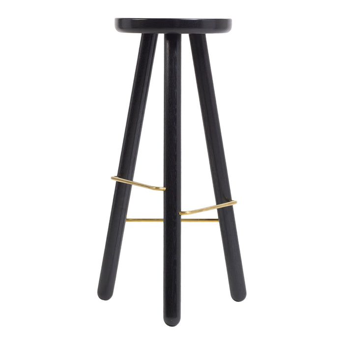 Black wooden stool with sleek legs and a gold metal support detail, featuring minimalistic design and modern style.