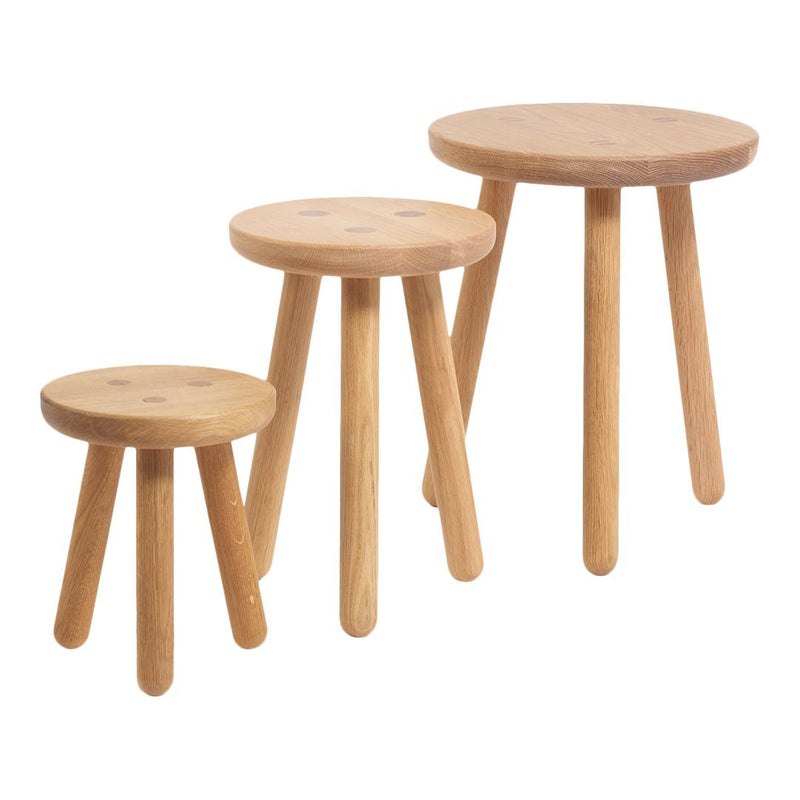 Set of three natural wood stools featuring a smooth finish and round tops with minimalistic design.