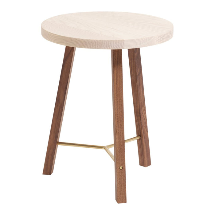Round wooden side table with a light natural top and dark walnut legs, featuring a subtle brass accent.