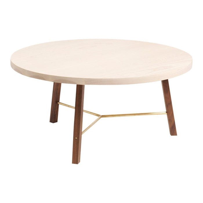 Light wood round coffee table with a natural finish, complemented by brown wooden legs and a gold metal accent.