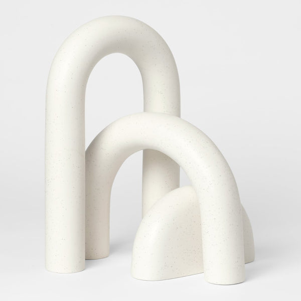 "Set of three elegant cream-colored geometric shapes with smooth, minimalistic curves and textures."