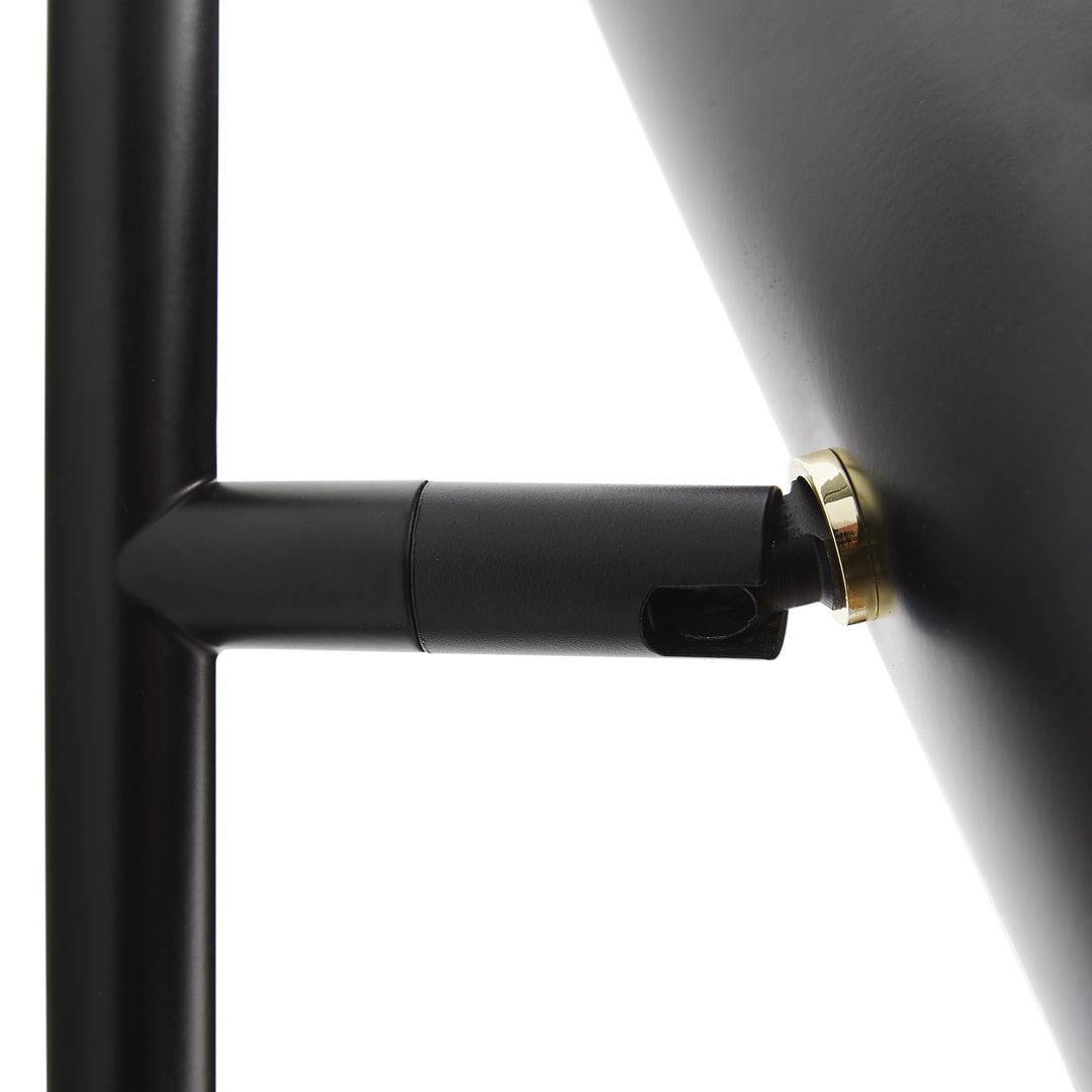 Black metal lamp with a sleek finish and brass accent details, showcasing a modern and minimalist design.