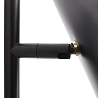 Black metal lamp with a sleek finish and brass accent details, showcasing a modern and minimalist design.