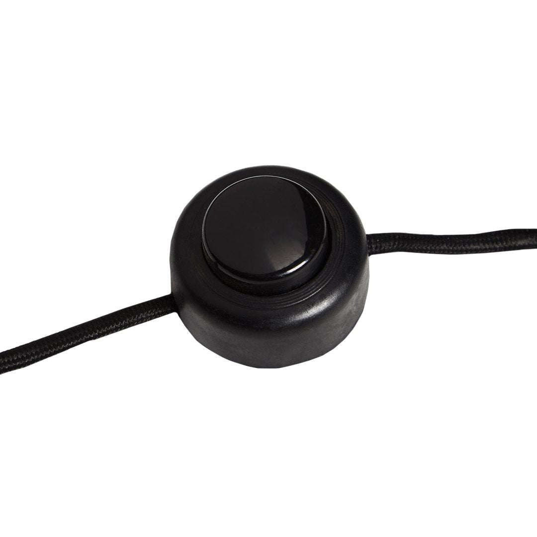 Black round switch with smooth surface and a black cord. Simple and modern design for easy operation.