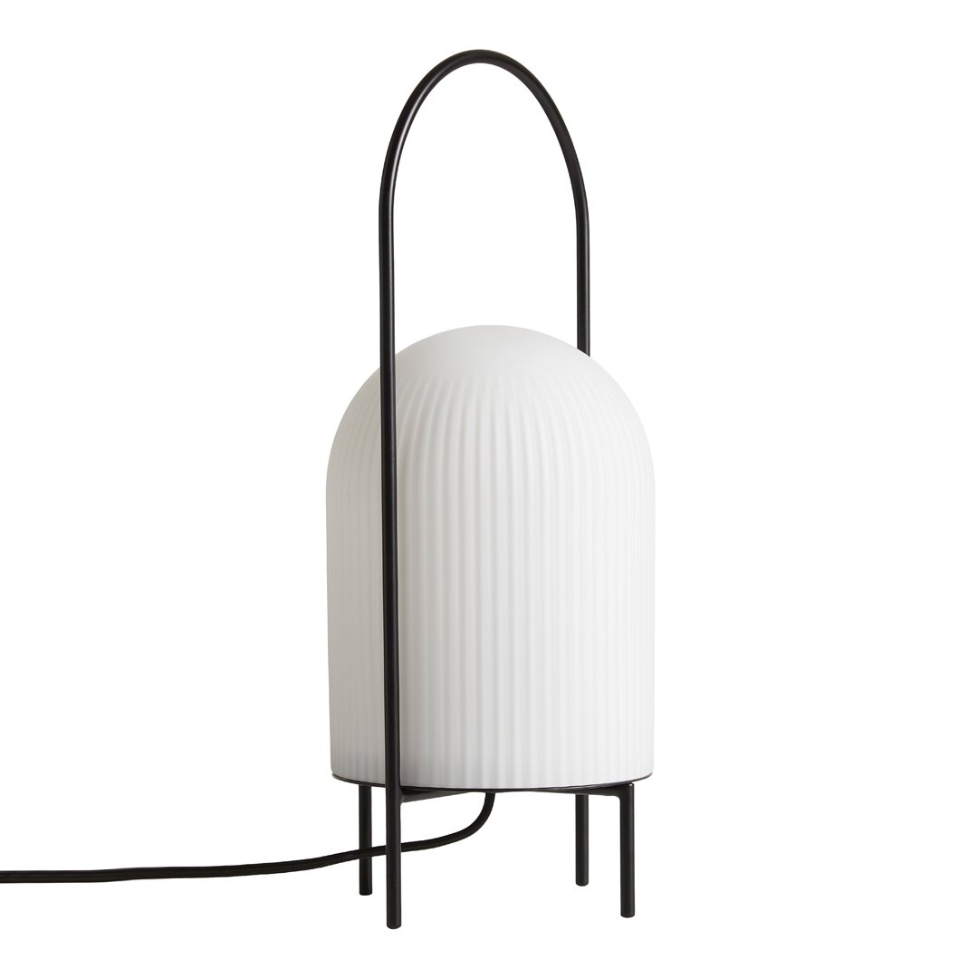 Modern white ribbed lamp with a sleek black frame and minimalist design, adding elegance to any space.