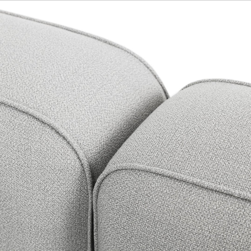 Close-up of textured light gray fabric with a subtle pattern, showcasing a modern and stylish design.