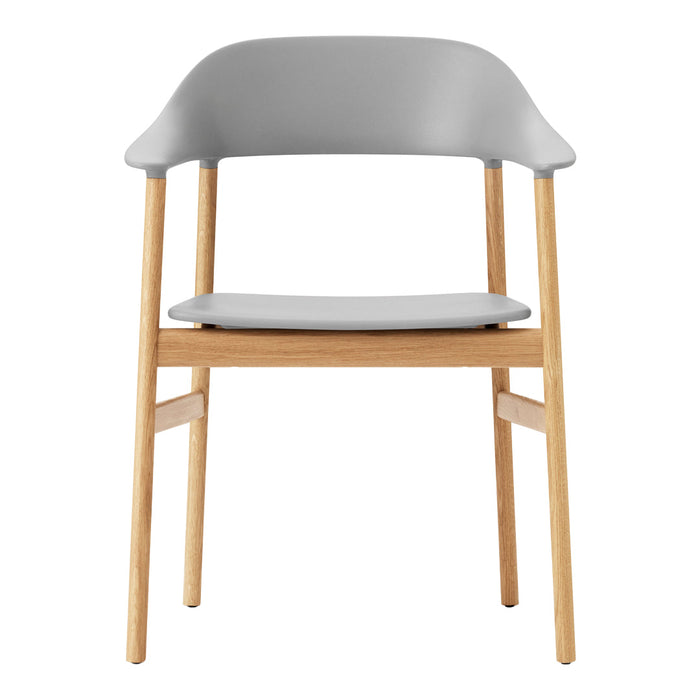 Gray molded chair with natural wooden legs, featuring a sleek and modern design. Ideal for contemporary decor.