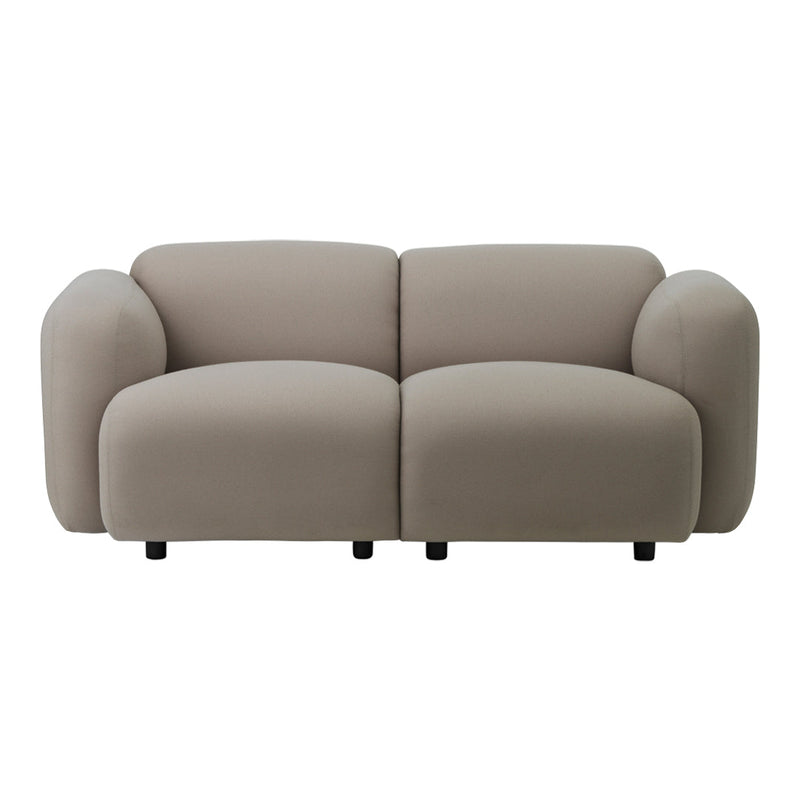 Stylish beige sofa with soft, rounded shapes and a smooth fabric texture, perfect for modern interiors.