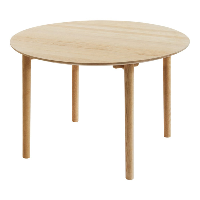 Round wooden table with a natural finish and smooth grain pattern, featuring light-toned legs for a minimalist look.
