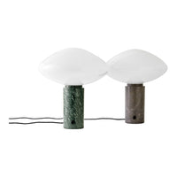 Green and gray marble lamp bases with sleek white glass globes, showcasing modern and elegant design elements.