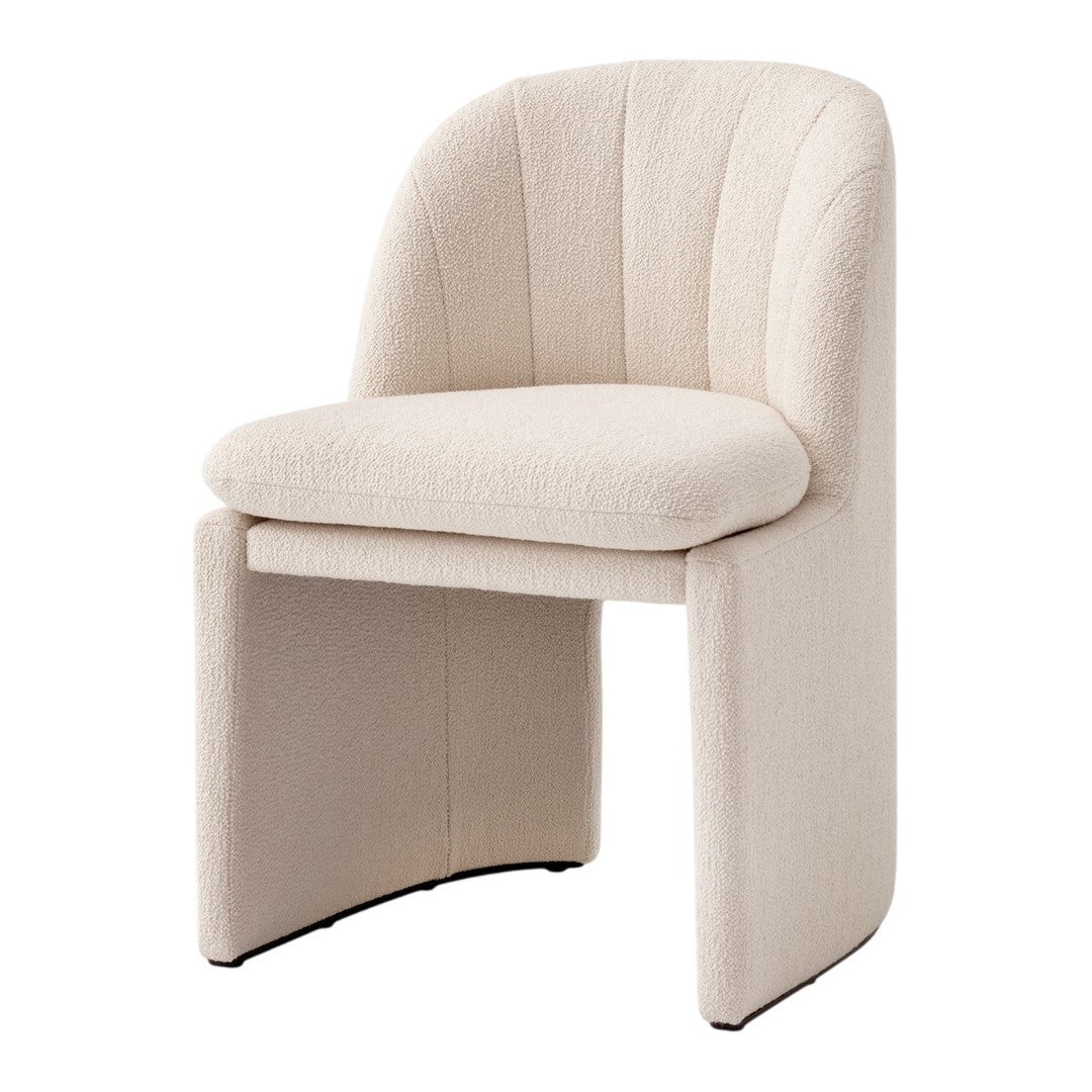 Beige textured chair with curved back and seat, featuring subtle stitch patterns for a modern, cozy aesthetic.