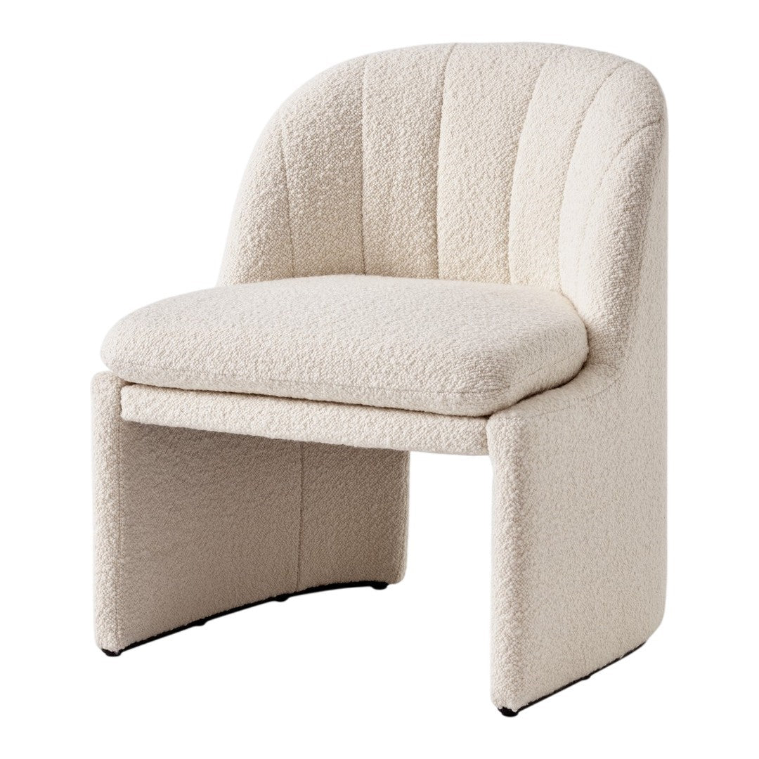 Textured cream accent chair with a curved back and thick cushioned seat, featuring subtle, soft patterns.