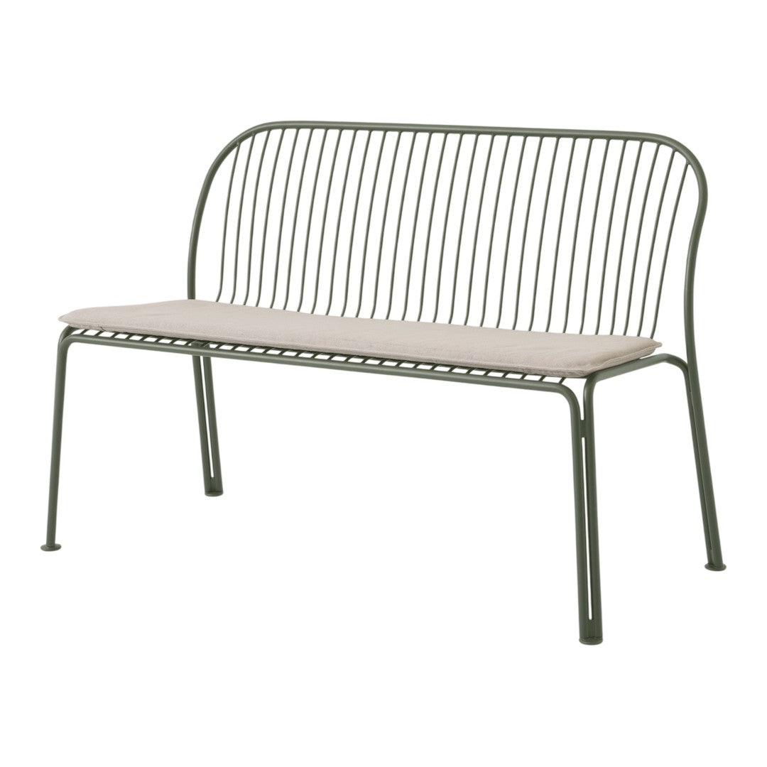 Green metal bench with a minimalist design and a beige cushion, featuring vertical lines and a sleek silhouette.