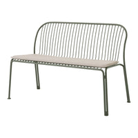 Green metal bench with a minimalist design and a beige cushion, featuring vertical lines and a sleek silhouette.