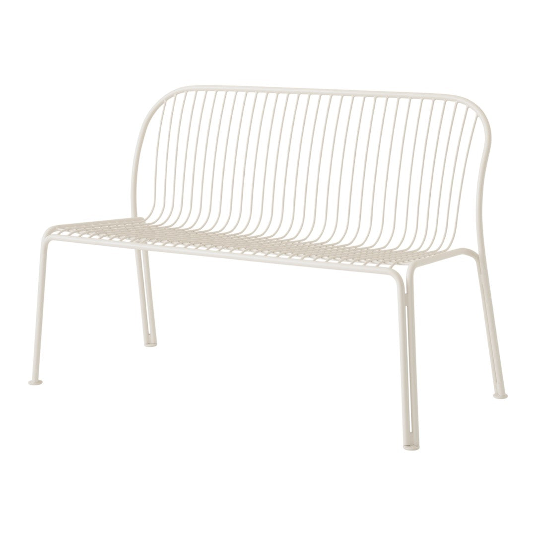 White metal bench with sleek, minimalist design featuring vertical line patterns for a modern aesthetic.