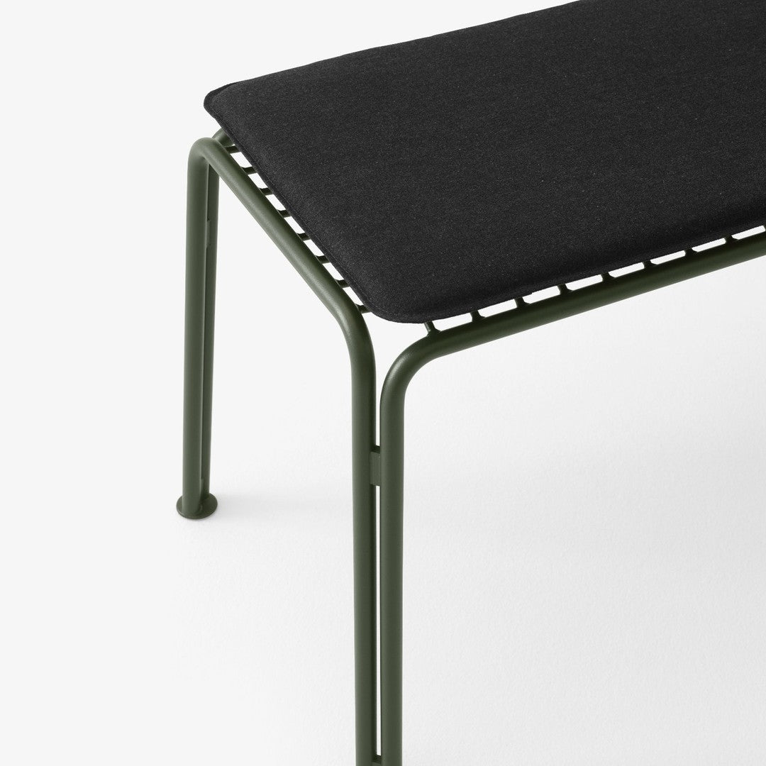 Black cushion atop an olive green metal frame with a sleek, minimalist design and lined detailing.