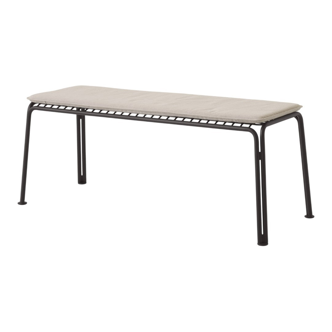Beige cushion bench with a sturdy black metal frame and minimalist design. Ideal for modern home decor.