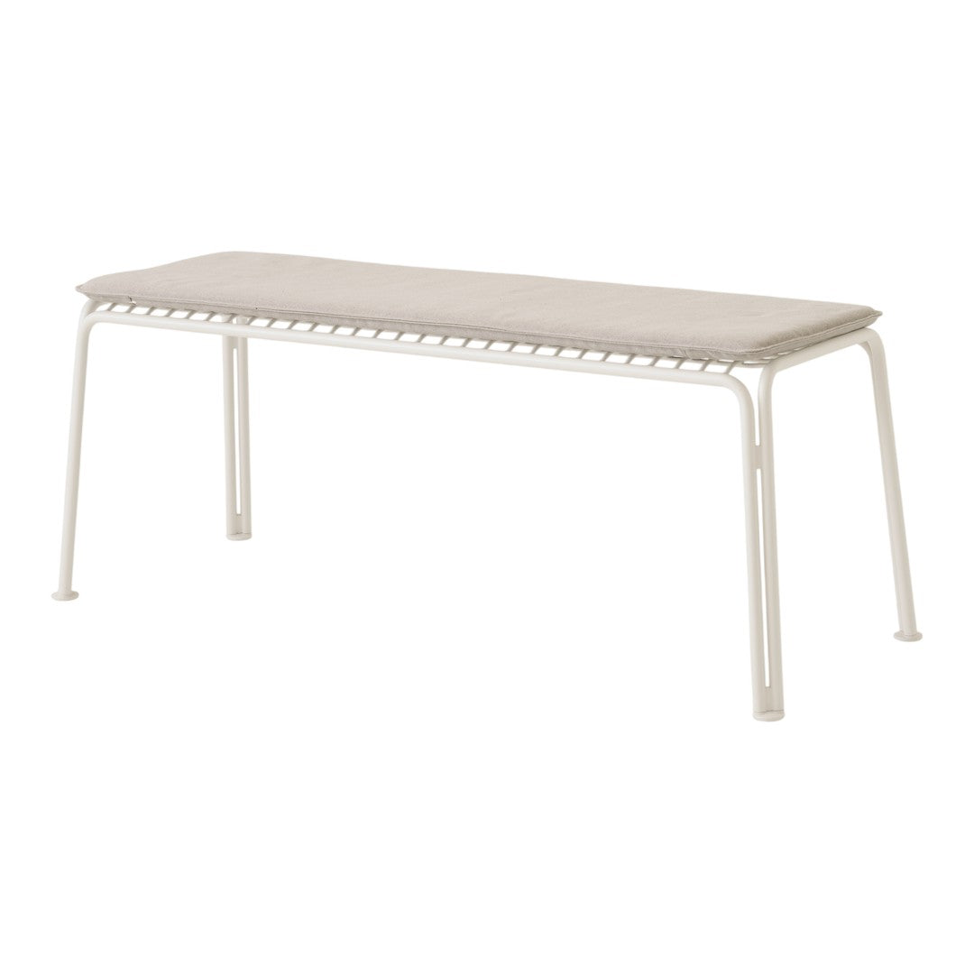Light beige bench with a textured surface and white metal legs, featuring a clean, modern design.