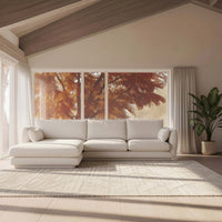 Modern white sectional sofa with a textured fabric, complemented by a light beige rug and warm autumnal window view.