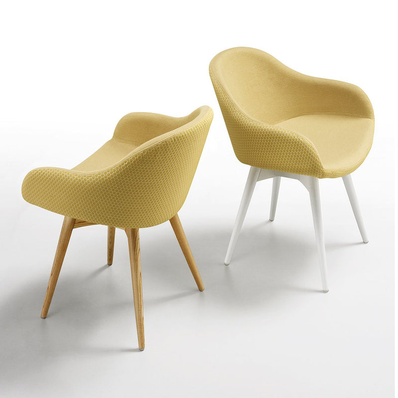 Yellow textured armchairs with wooden and white legs, showcasing a modern, minimalist design.