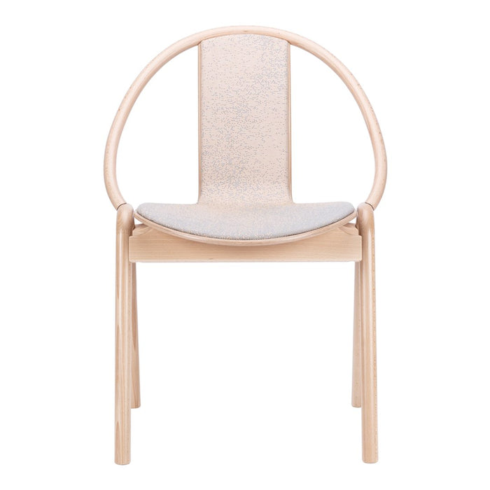 Light wood chair with a rounded backrest and a soft gray patterned seat, perfect for modern decor.