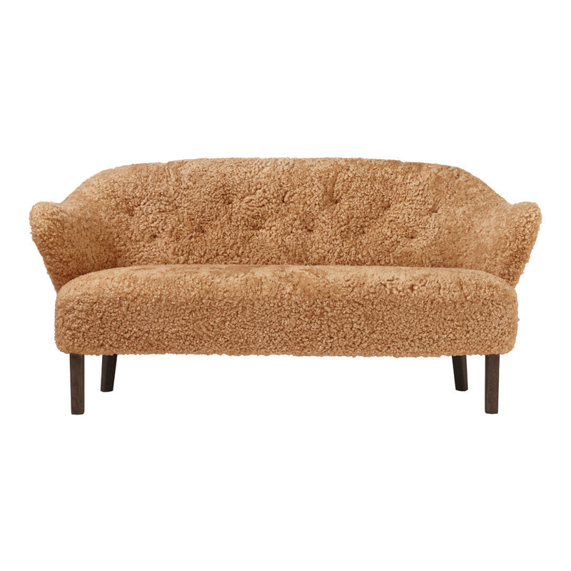 Soft, textured beige couch with a tufted design and dark wooden legs, perfect for cozy living spaces.