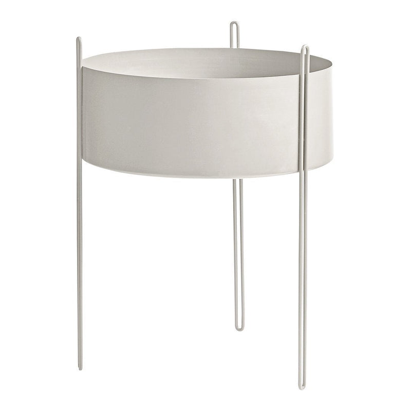 Minimalist round planter in soft white with sleek metal legs, perfect for modern decor.