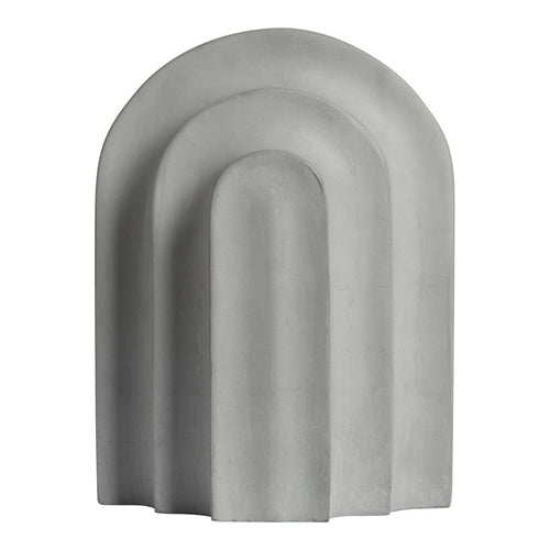 Gray arch-shaped sculpture with smooth curves and a minimalist design, featuring layered patterns.
