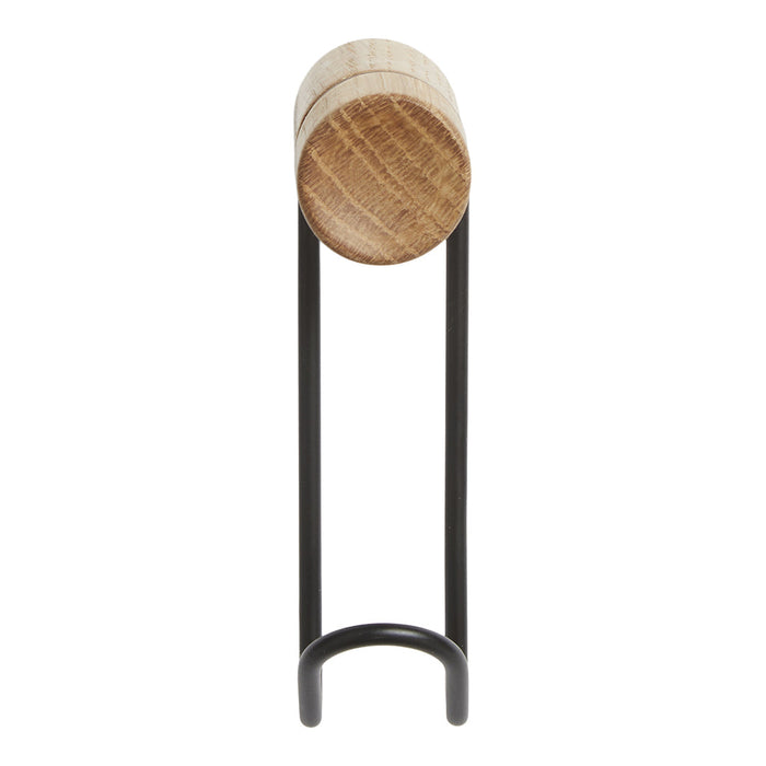Natural wood grain on a round top with a sleek black metal stand, combining rustic charm and modern design.