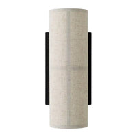 Light gray cylindrical lamp shade with a textured pattern, accented by a sleek black wall mount.