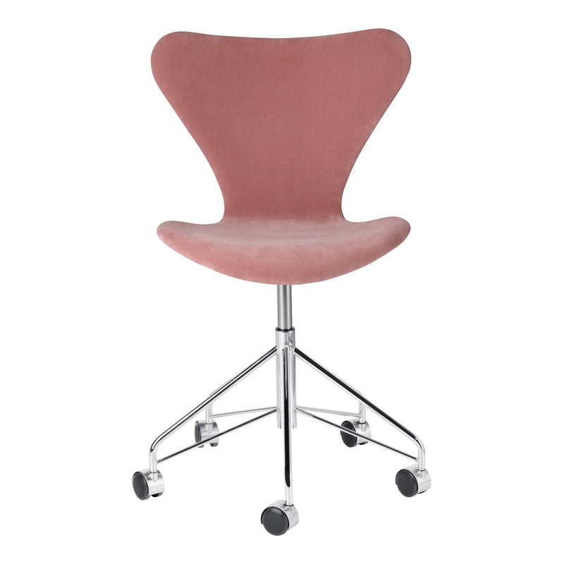 Pink velvet chair with a sleek curved design, featuring a chrome base and rolling wheels for easy mobility.